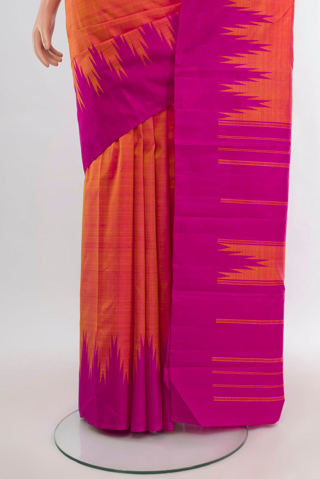 Pleats and pallu of Orange Kanjivaram Silk Saree with Plain Body and Temple Border. 