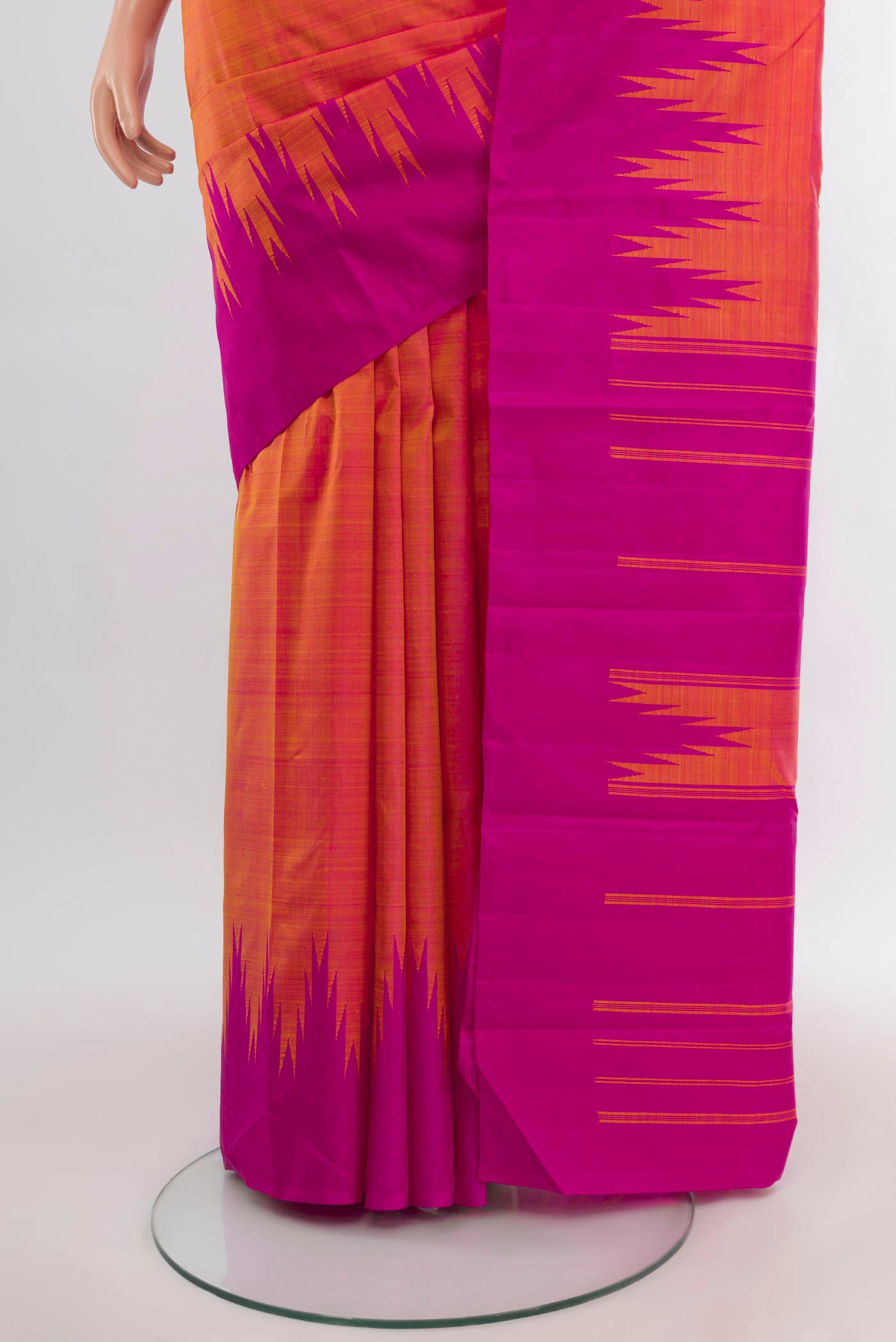 Pleats and pallu of Orange Kanjivaram Silk Saree with Plain Body and Temple Border. 