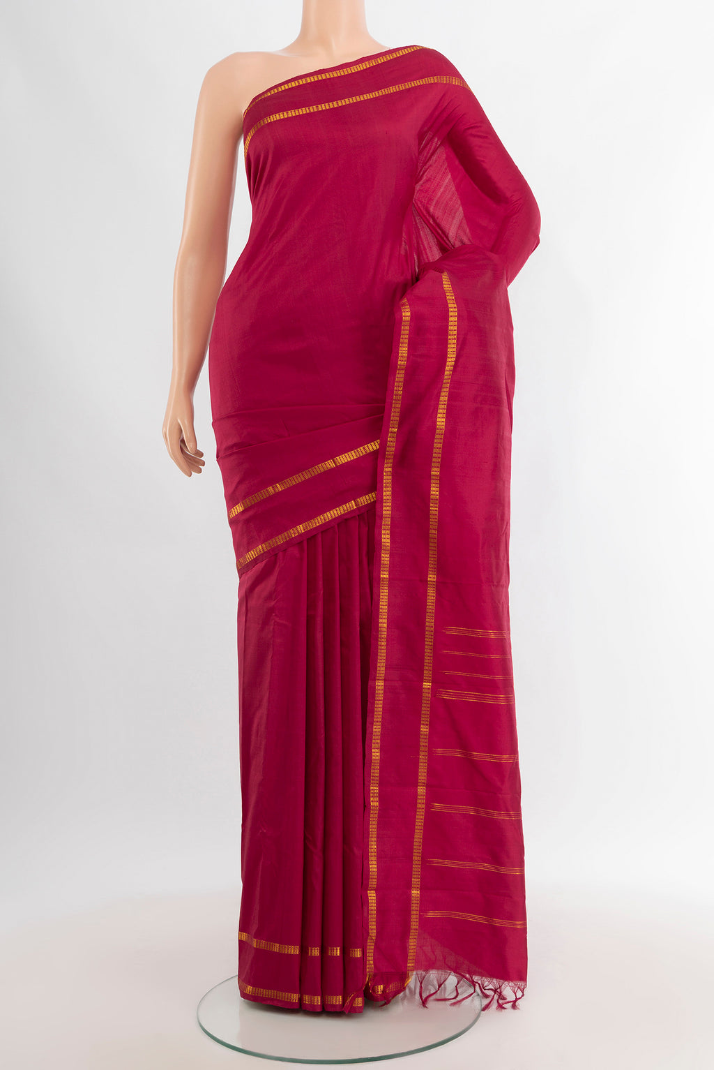 Maroon Kanchipuram Silk Saree with Plain Body and Zari Border.  displayed on a mannequin