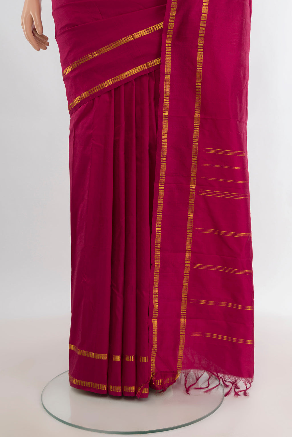 Pleats and pallu of Maroon Kanchipuram Silk Saree with Plain Body and Zari Border. 