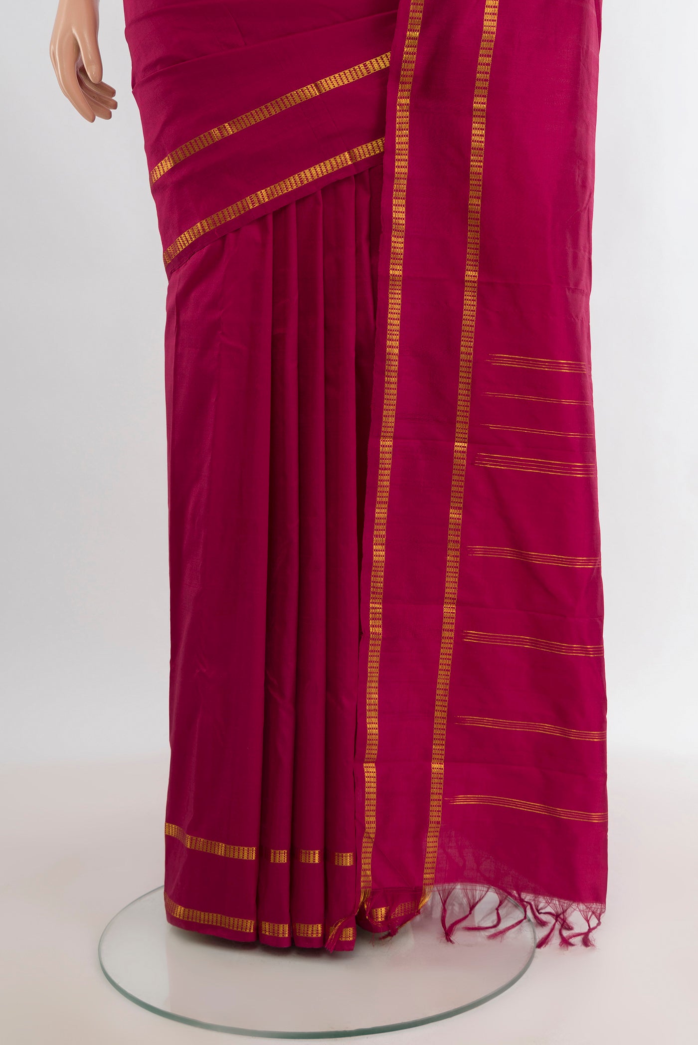 Pleats and pallu of Maroon Kanchipuram Silk Saree with Plain Body and Zari Border. 