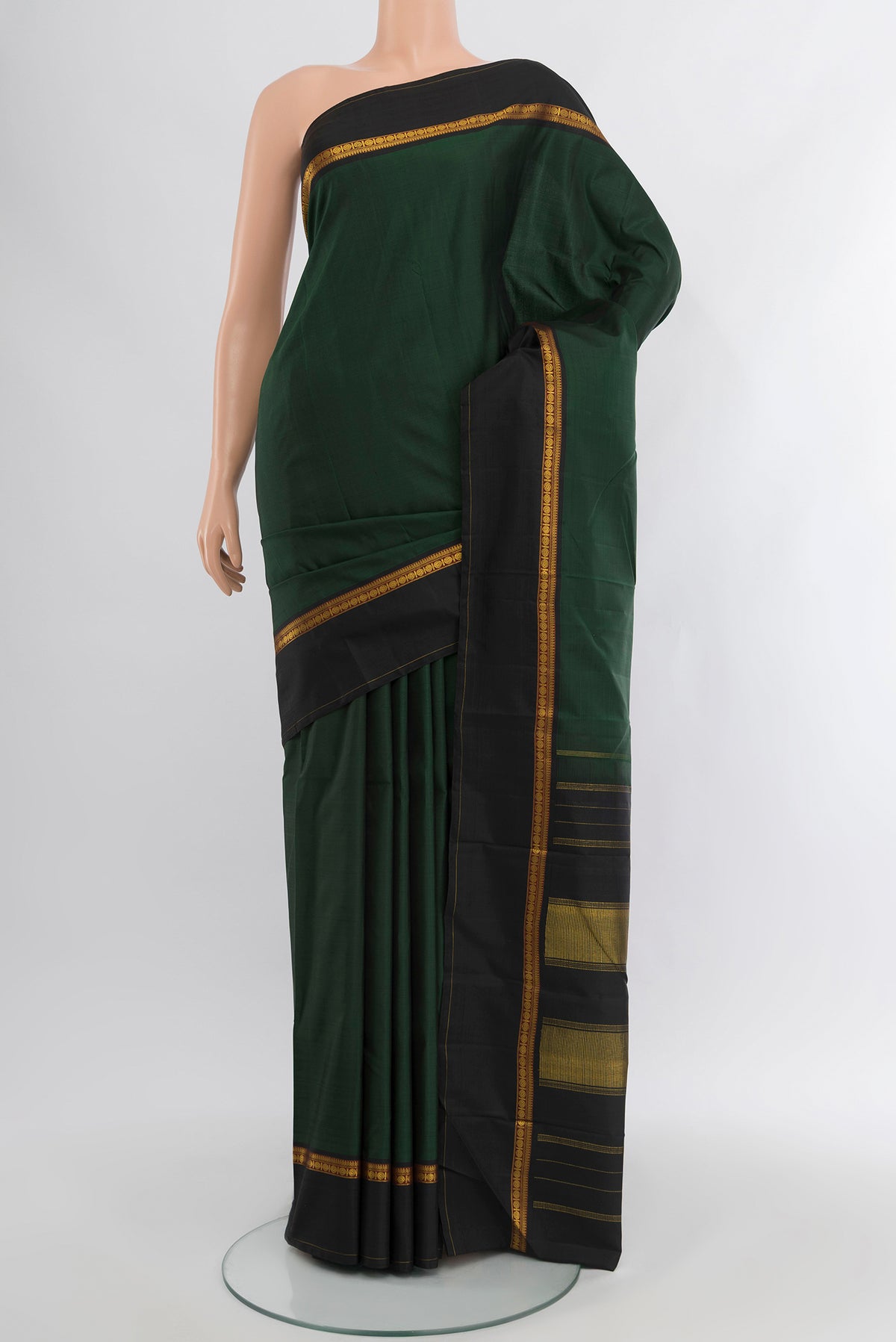 Bottle Green Kanchipuram Silk Saree with Plain Body and Plain Border.  displayed on a mannequin