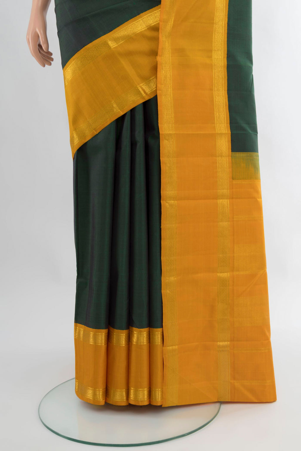 Pleats and pallu of Bottle Green Kanjivaram Silk Saree with Plain Body and Zari Border. 