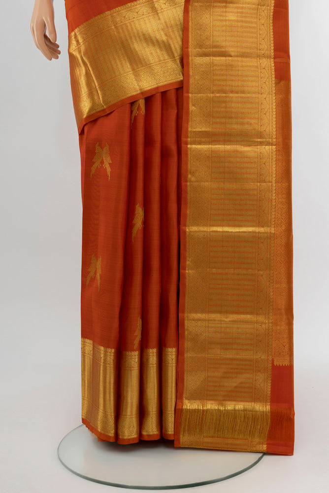 Pleats and pallu of Brick Orange Kanjivaram Silk Saree with Zari Butta on the body and Silk Border. 