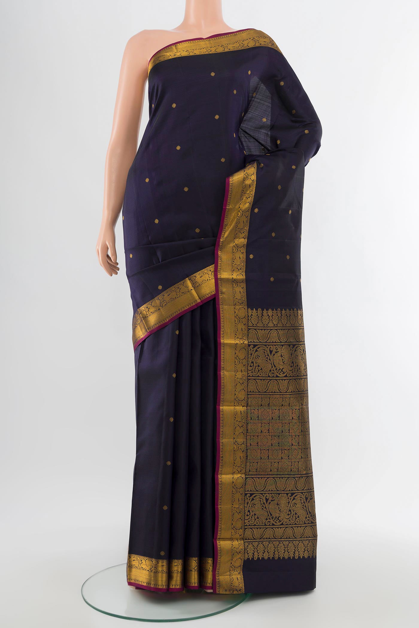 Pure Silk Pure Zari Navy Blue Kanjivaram Saree with Zari Butta on the body and Silk Border.  displayed on a mannequin