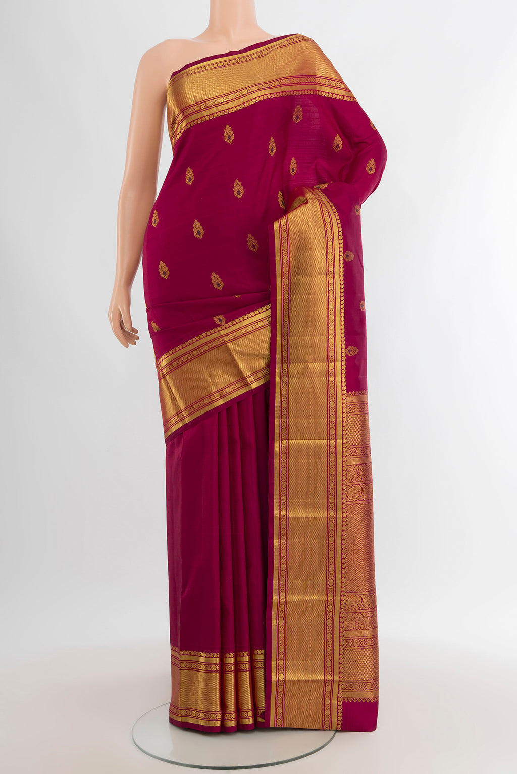 Maroon Kanjivaram Silk Saree with Zari Butta on the body and Zari Border.  displayed on a mannequin