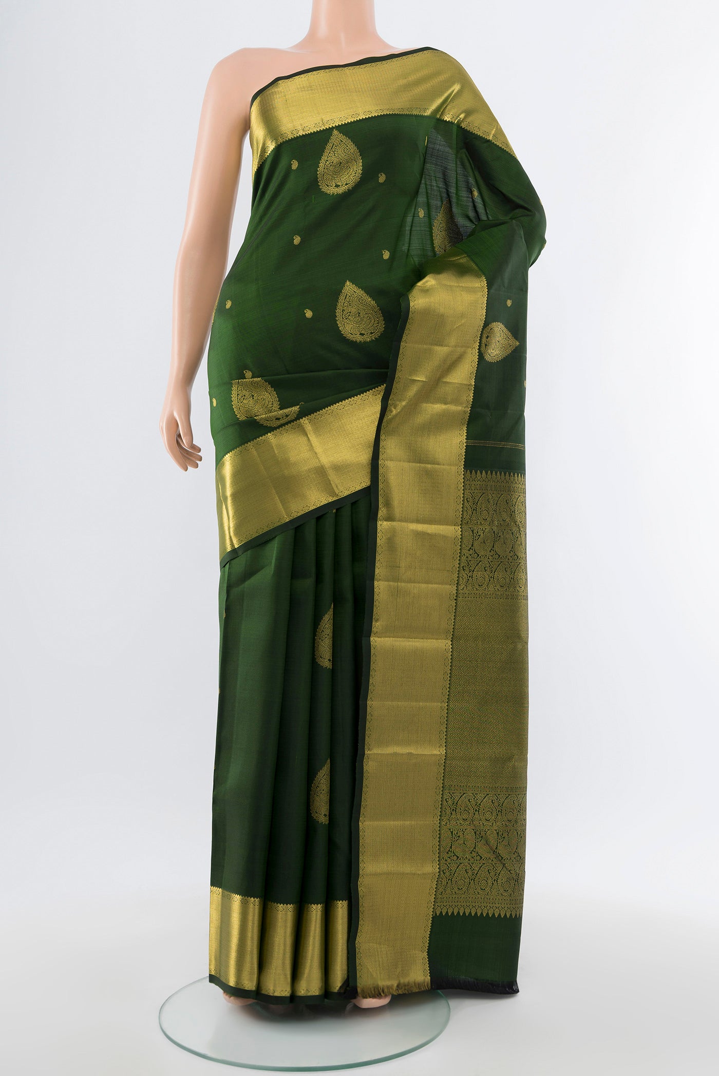 Bottle Green Kanjivaram Silk Saree with Zari Butta on the body and Silk Border.  displayed on a mannequin