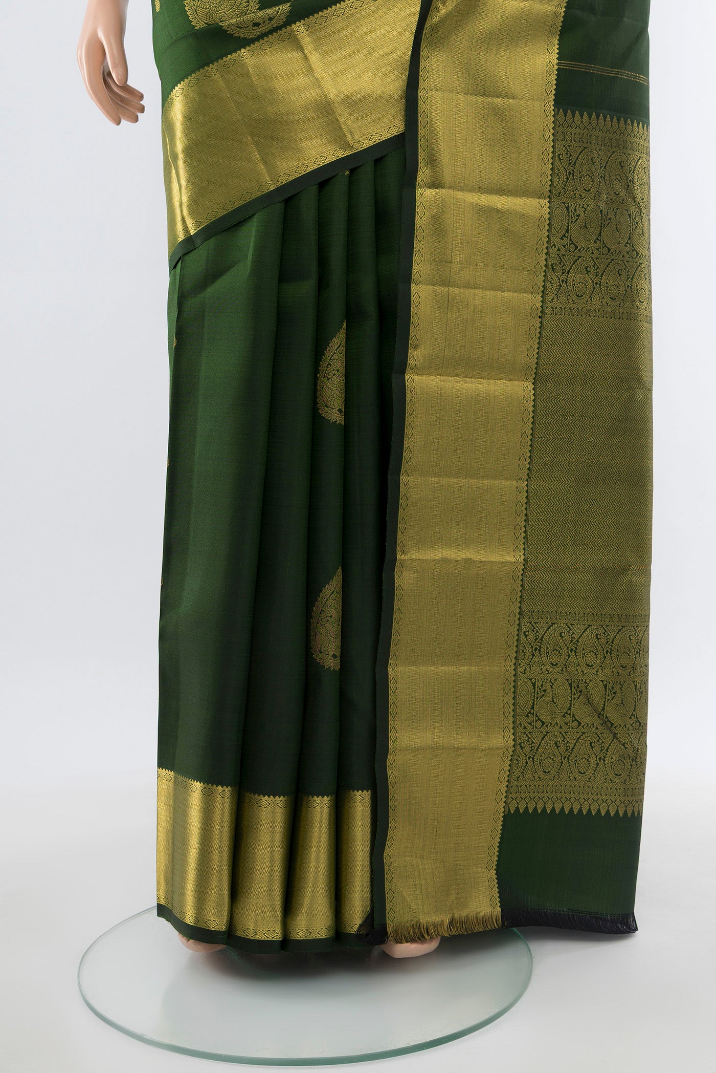 Pleats and pallu of Bottle Green Kanjivaram Silk Saree with Zari Butta on the body and Silk Border. 