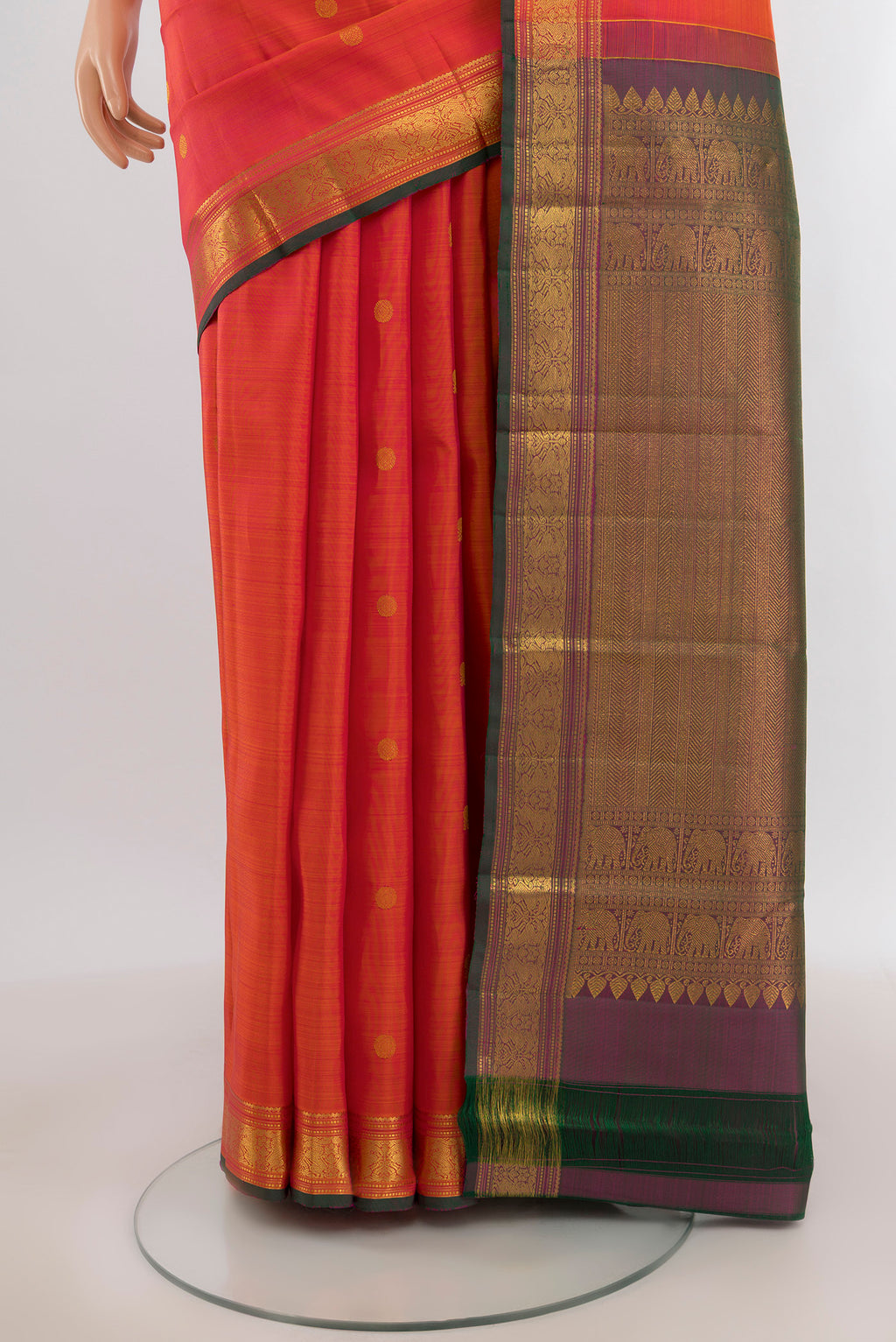 Pleats and pallu of Brick Orange Kanjivaram Silk Saree with Zari Butta on the body and Zari Border. 