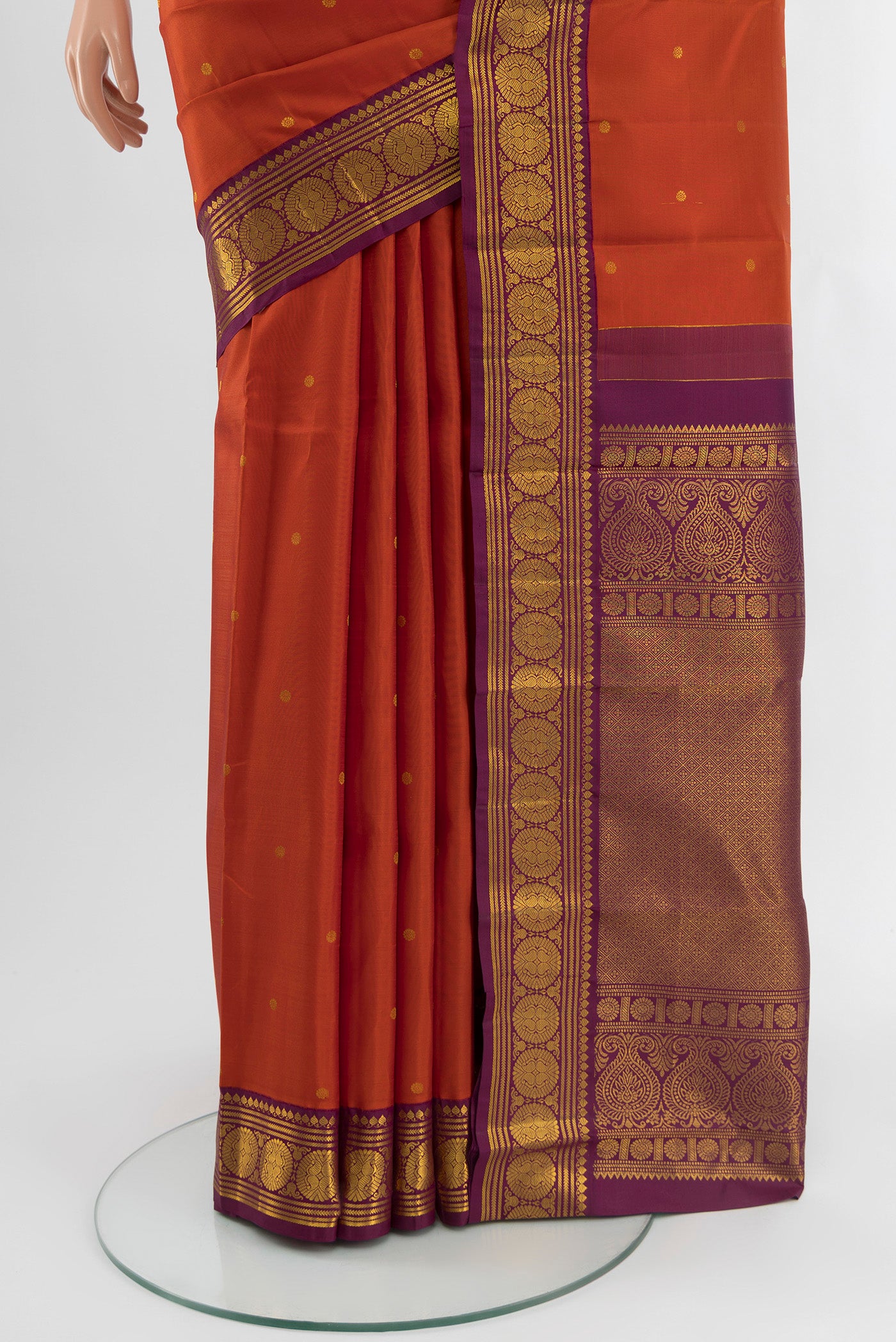 Pleats and pallu of Rust Kanjivaram Silk Saree with Zari Butta on the body and Zari Border. 