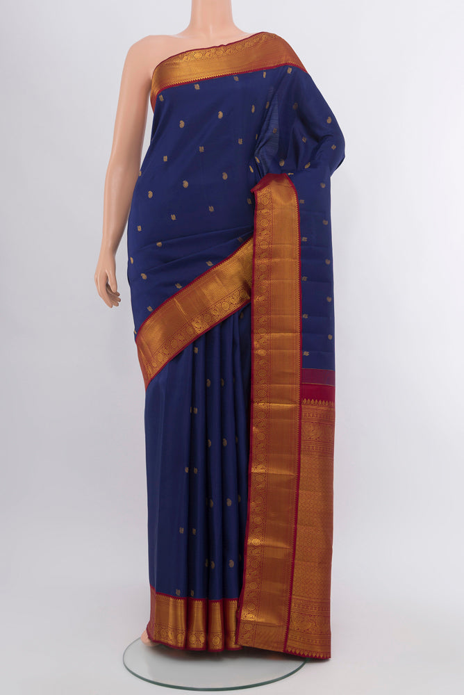 Dark Blue Kanjivaram Silk Saree with Zari Butta on the body and Silk Border.  displayed on a mannequin