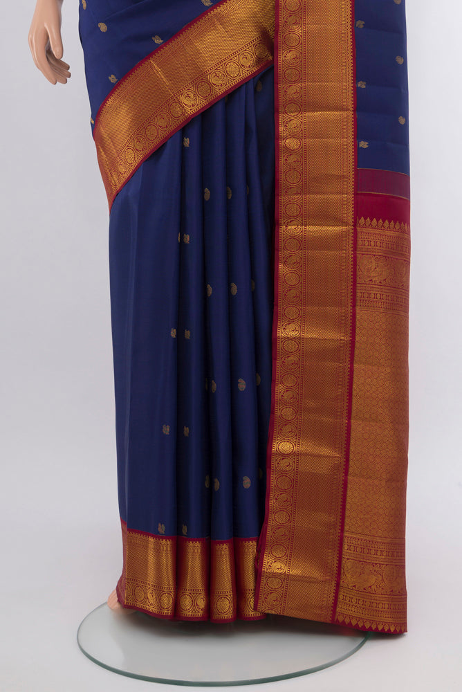 Pleats and pallu of Dark Blue Kanjivaram Silk Saree with Zari Butta on the body and Silk Border. 