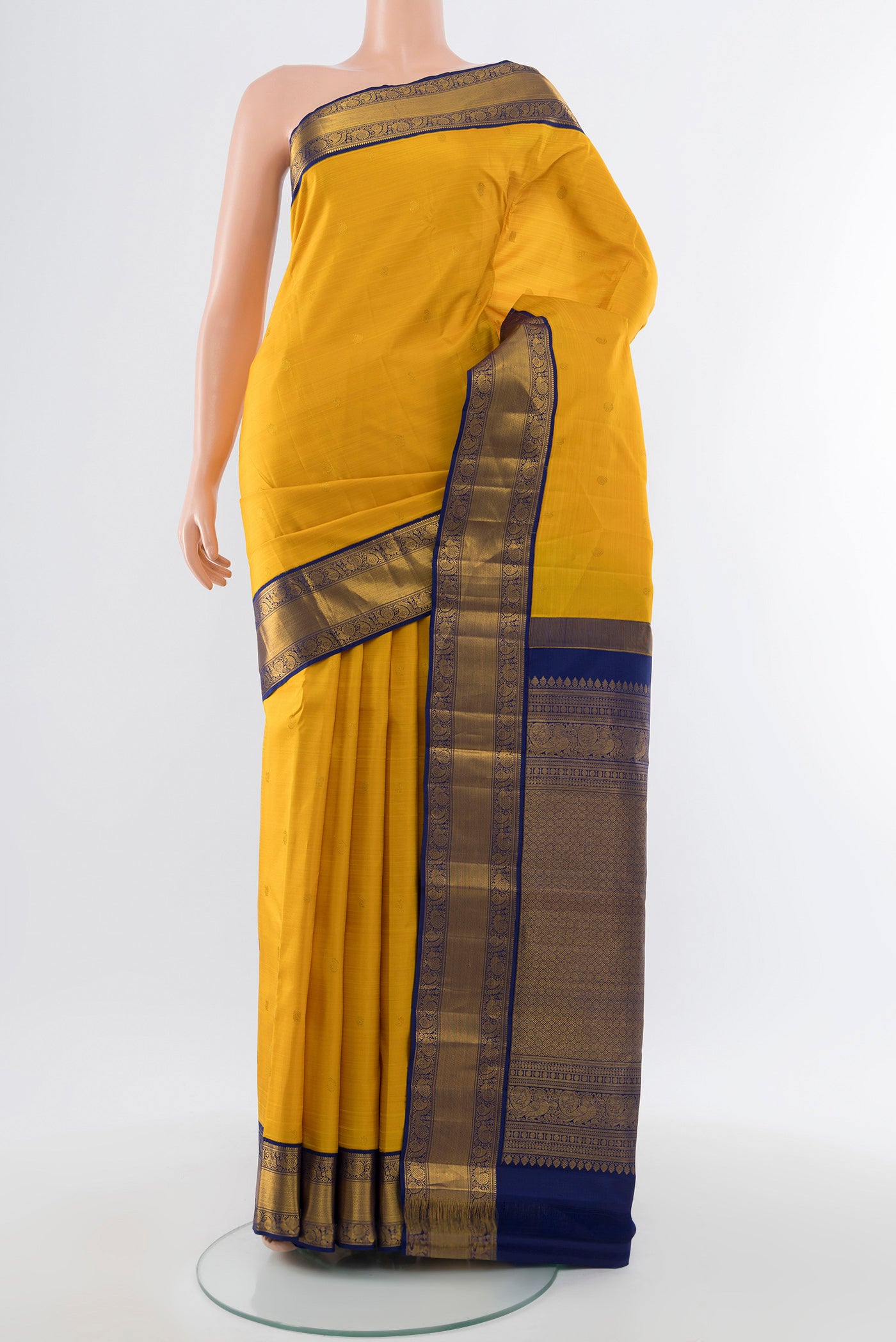 Yellow Kanjivaram Silk Saree with Zari Butta on the body and Silk Border.  displayed on a mannequin