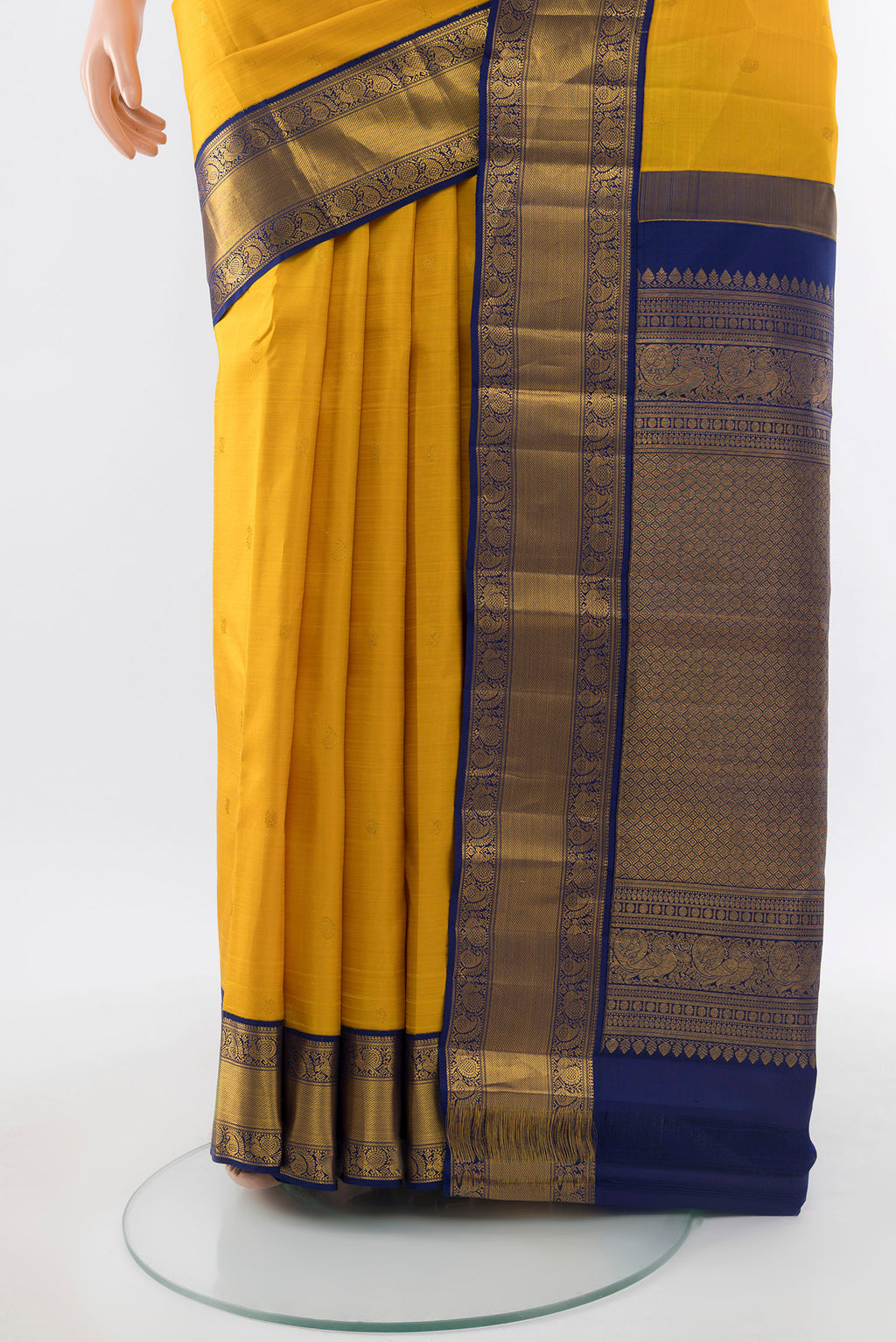 Pleats and pallu of Yellow Kanjivaram Silk Saree with Zari Butta on the body and Silk Border. 