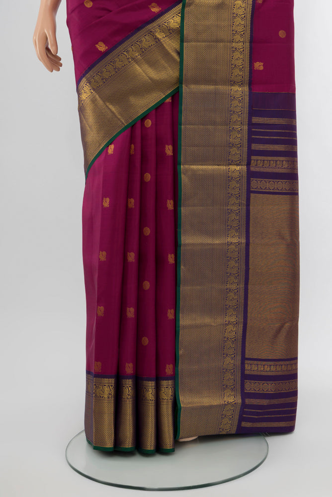 Pleats and pallu of Purple Kanjivaram Silk Saree with Zari Butta on the body and Silk Border. 