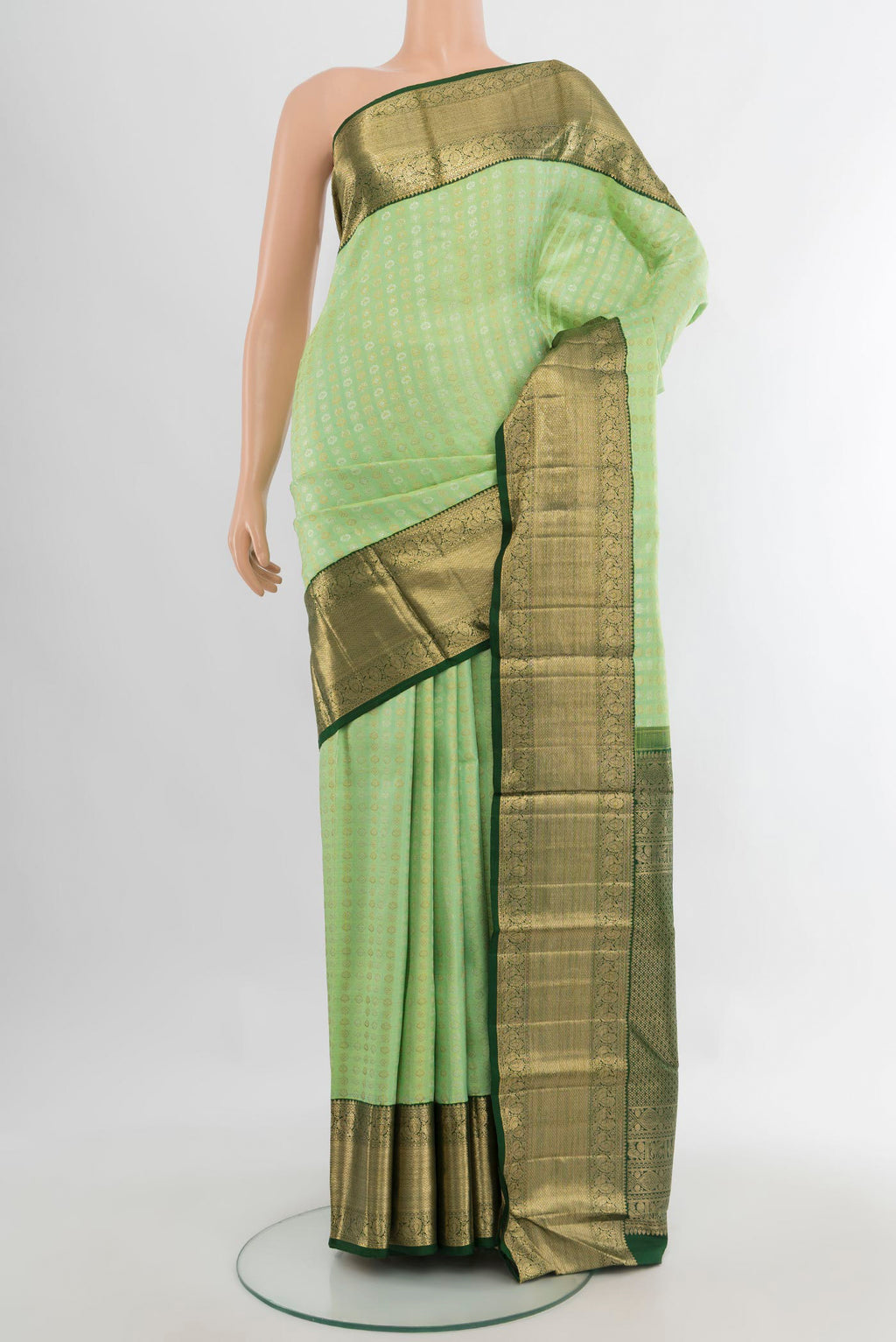 Pure Silk Pista Green Kanchipuram Saree with Zari Brocade on the body and Zari Border.  displayed on a mannequin