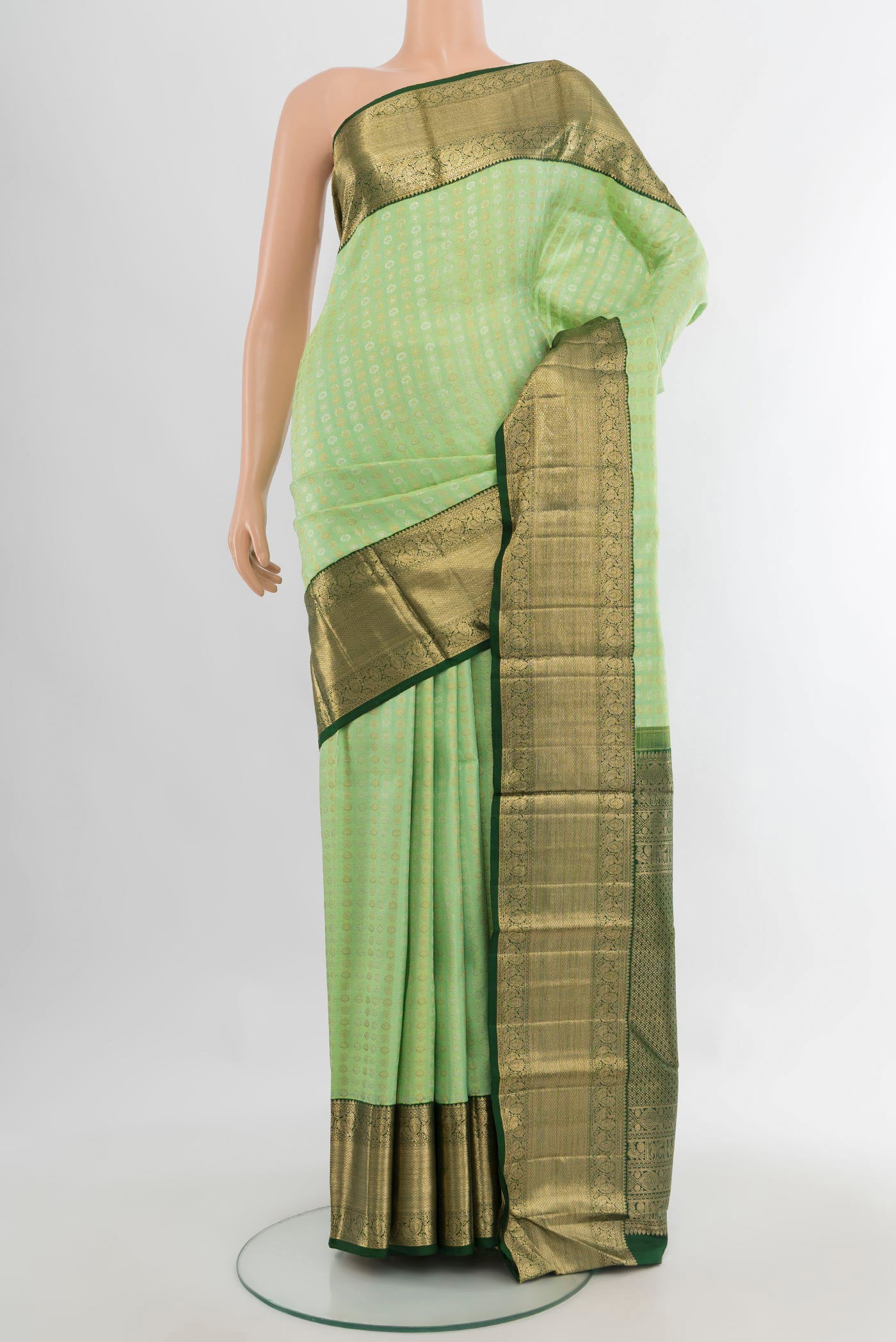 Pure Silk Pista Green Kanchipuram Saree with Zari Brocade on the body and Zari Border.  displayed on a mannequin