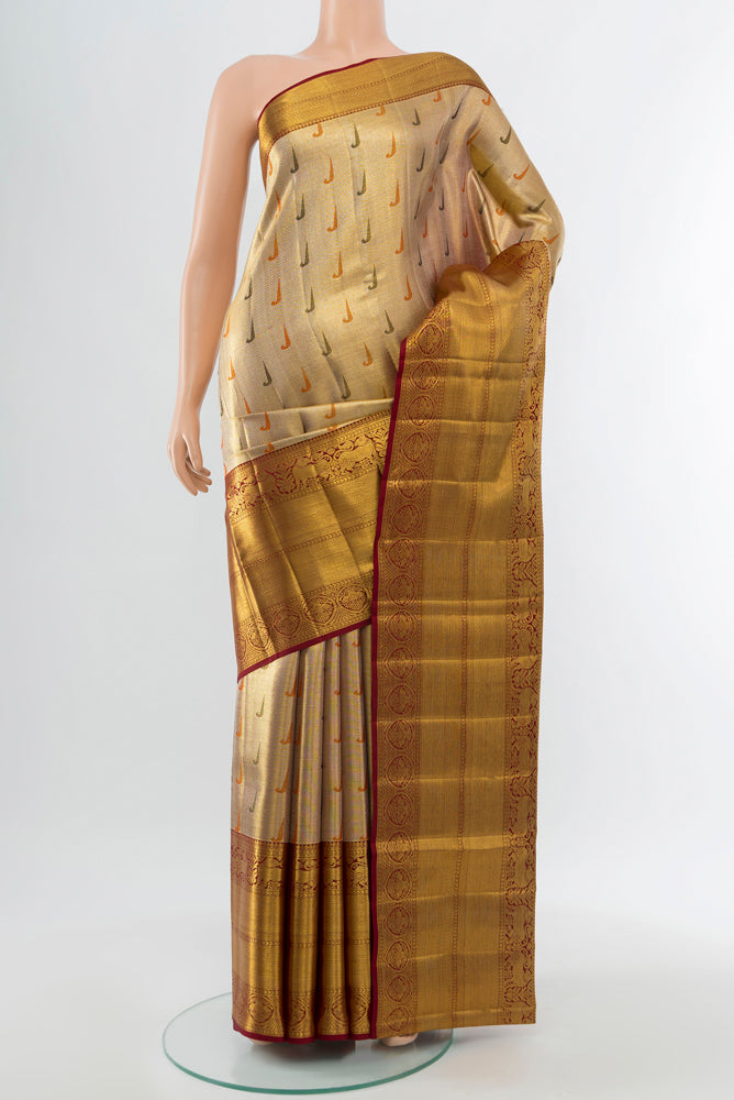 Golden Kanjivaram Silk Saree with Zari Butta on the body and Silk Border.  displayed on a mannequin