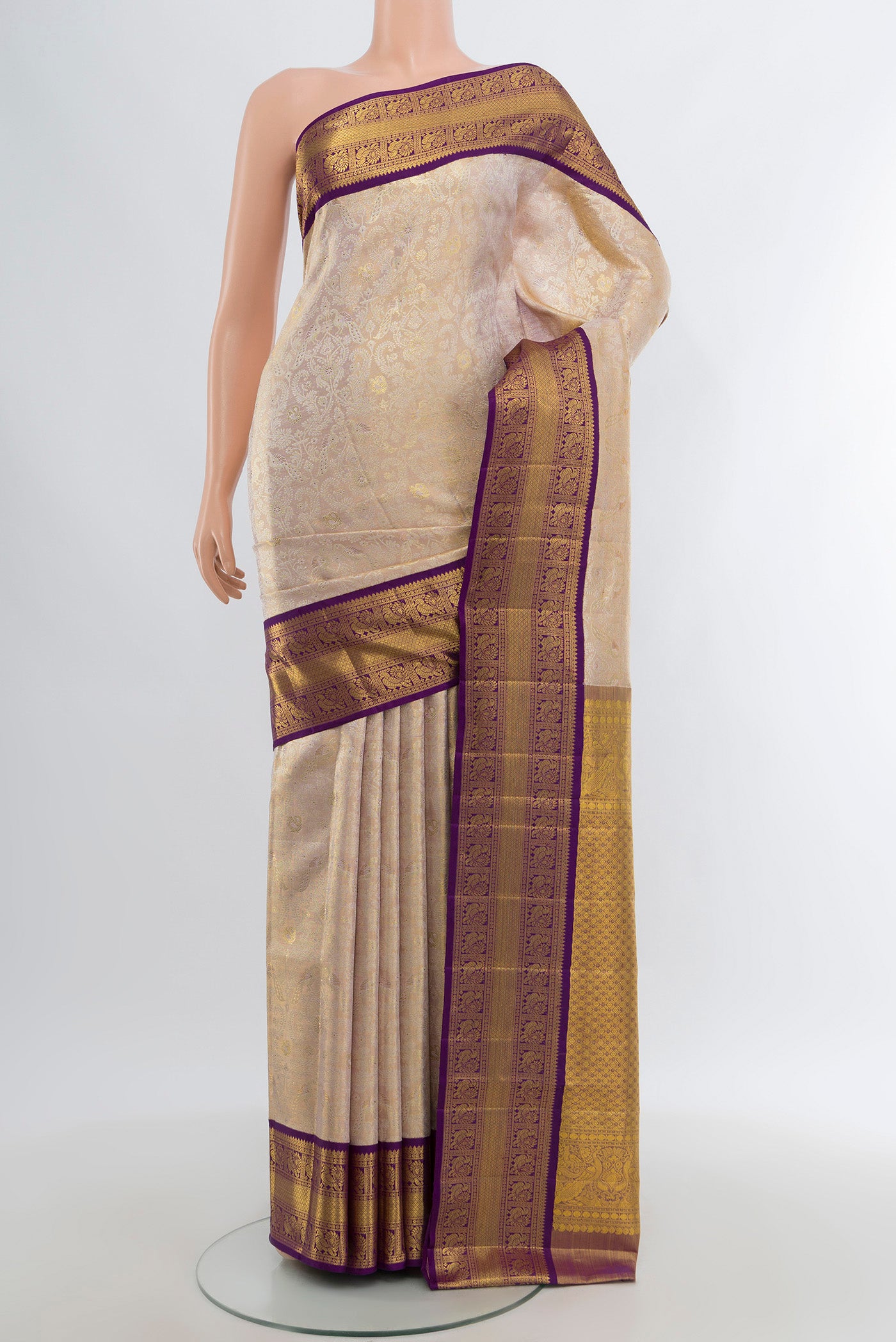 Cream Kanjivaram Tissue Silk Saree with Zari Brocade on the body and Zari Border.  displayed on a mannequin