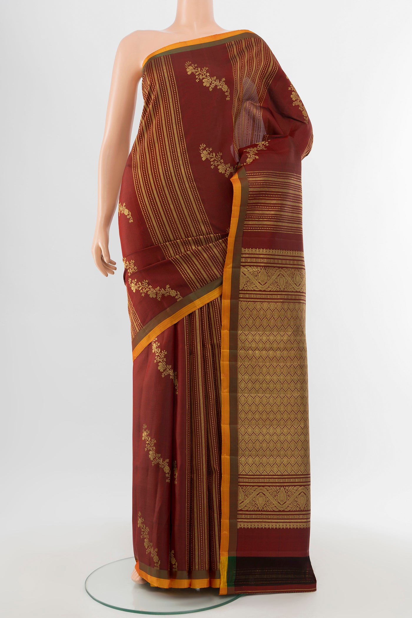 Pure Silk Pure Zari Maroon Kanjivaram Saree with Zari Butta on the body and Silk Border.  displayed on a mannequin