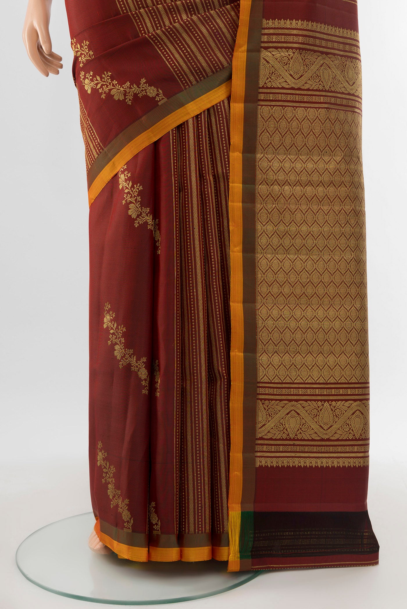 Pleats and pallu of Pure Silk Pure Zari Maroon Kanjivaram Saree with Zari Butta on the body and Silk Border. 