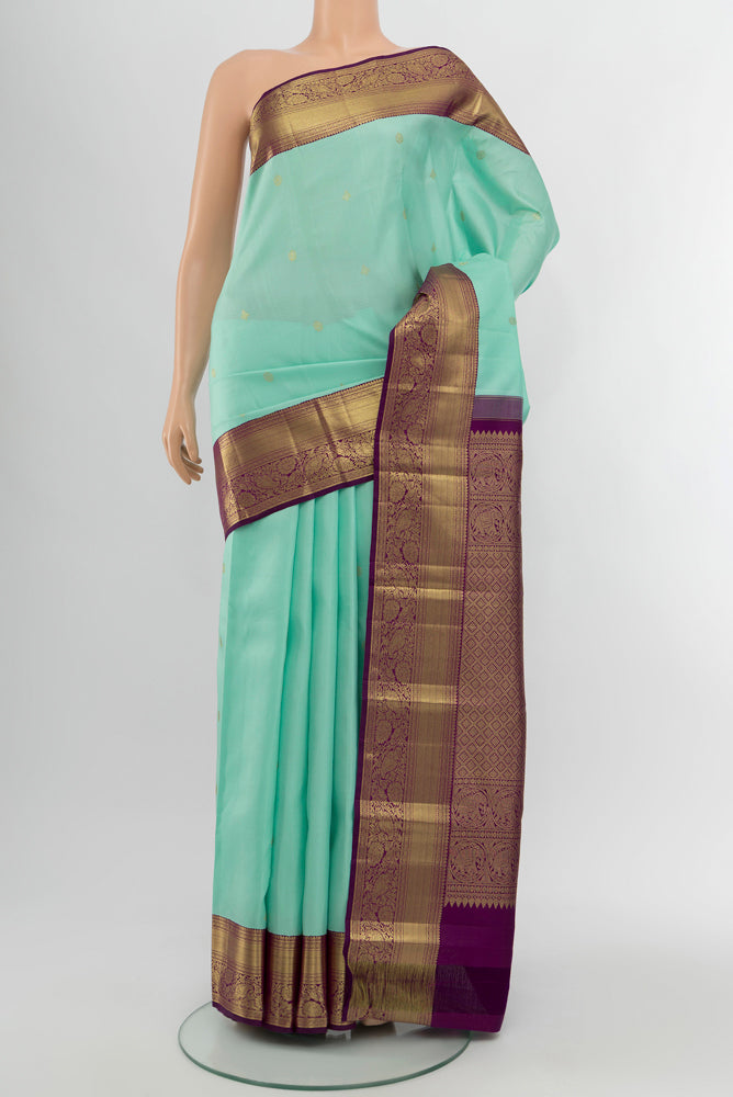 Sky Blue Kanjivaram Silk Saree with Zari Butta on the body and Silk Border.  displayed on a mannequin