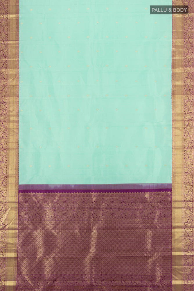 Flat view of Sky Blue Kanjivaram Silk Saree with Zari Butta on the body and Silk Border. 