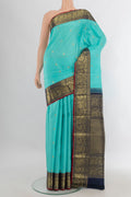 Pure Silk Turquoise Kanjivaram Saree with Zari Butta on the body and Zari Border.  displayed on a mannequin