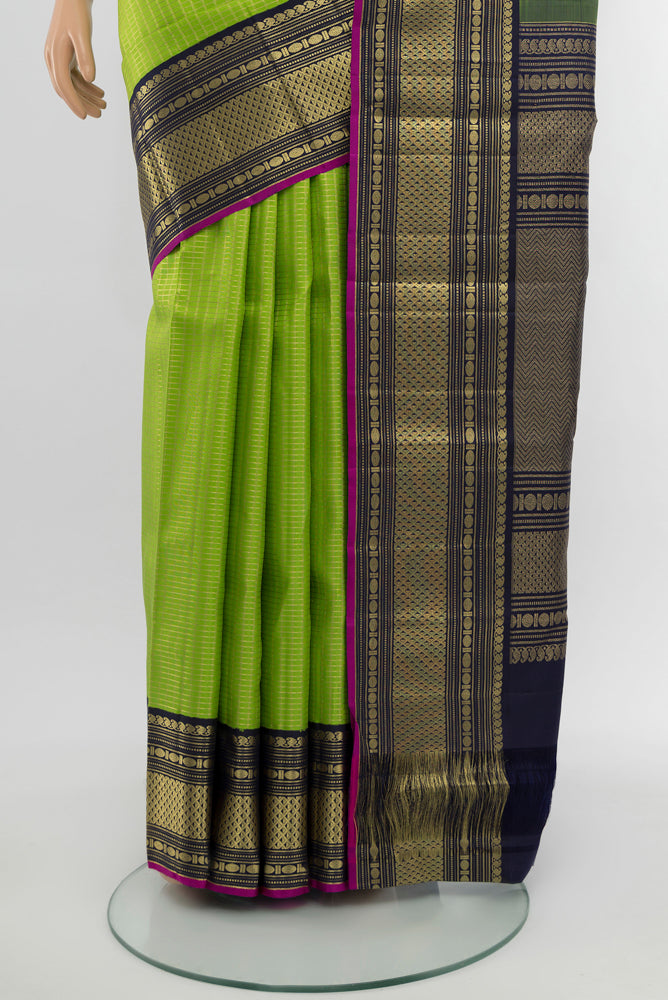 Pleats and pallu of Light Green Kanchipuram Silk Saree with Zari Butta on the body and Silk Border. 