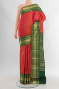 Orange Kanchipuram Silk Saree with Checked design on the body and Zari Border.  displayed on a mannequin