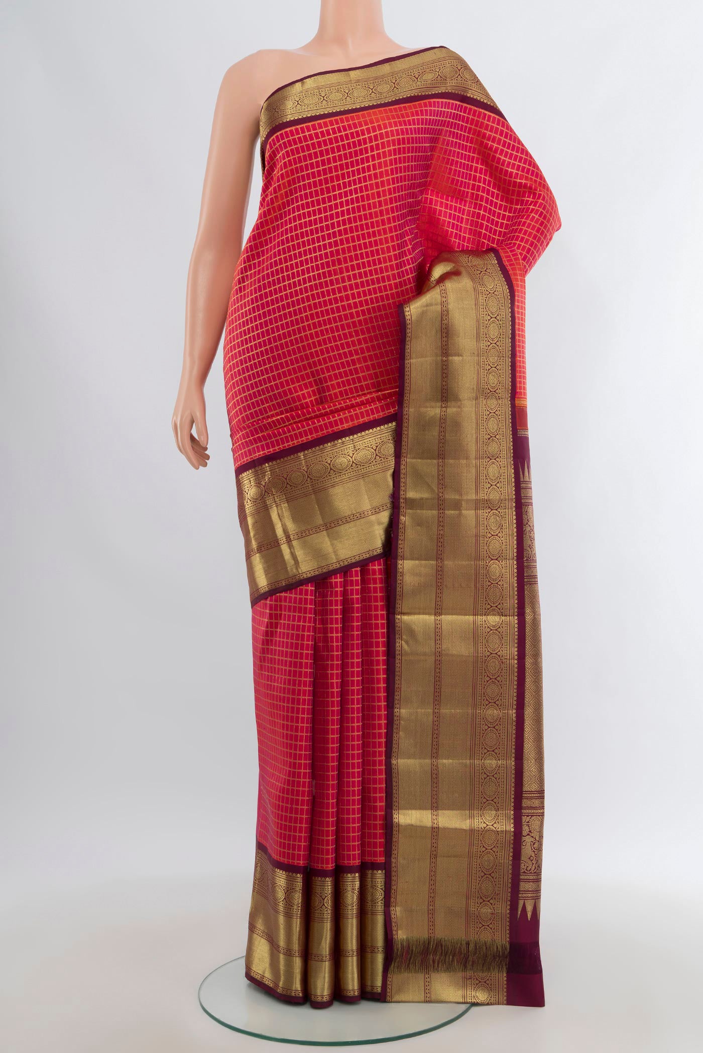 Pink Kanchipuram Silk Saree with Zari Butta on the body and Zari Border.  displayed on a mannequin