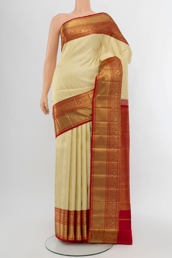 Golden Kanchipuram Silk Saree with Zari Butta on the body and Silk Border.  displayed on a mannequin
