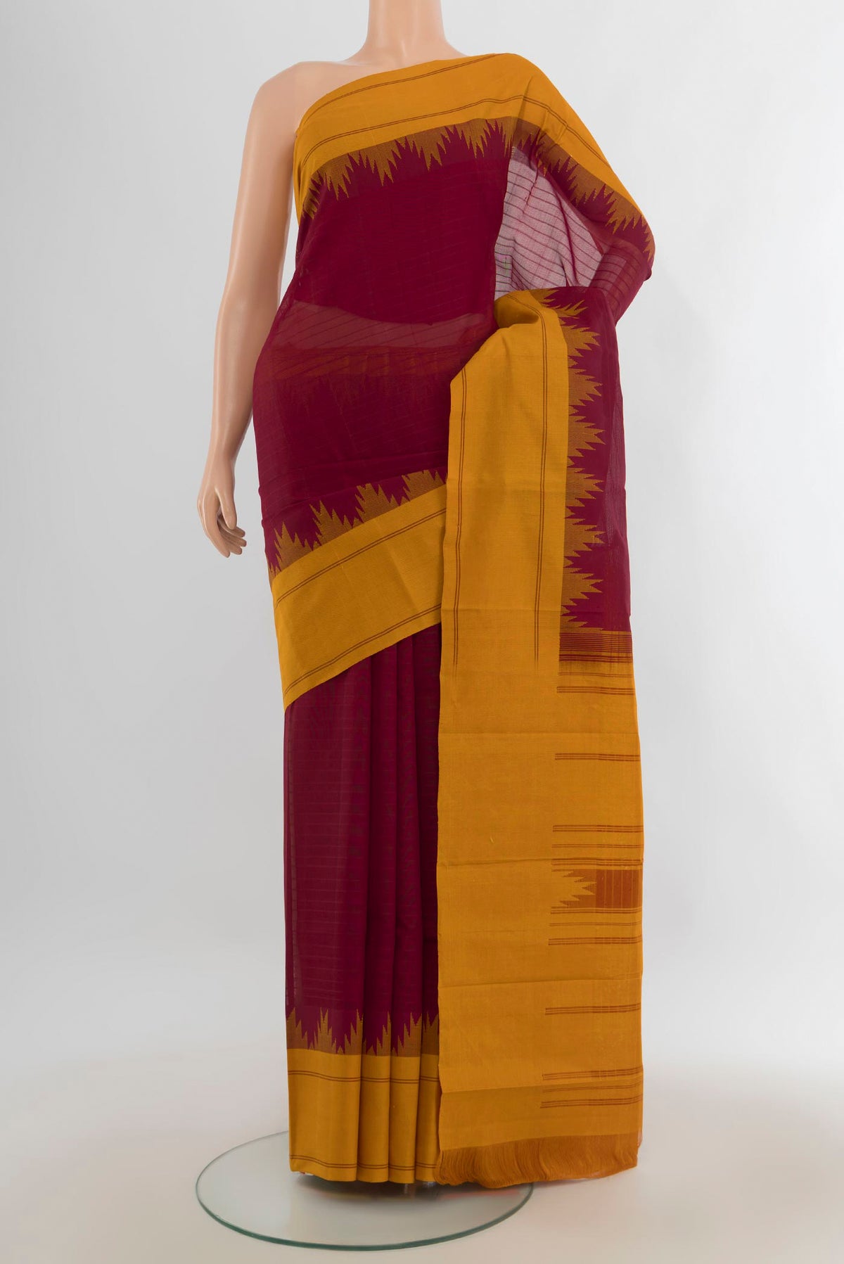 Maroon Kanchi Cotton Saree with Plain Body and Silk Border.  displayed on a mannequin
