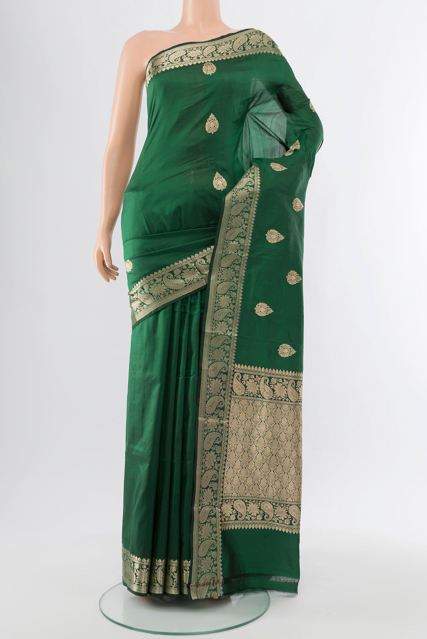 Bottle Green Banarasi Katan Silk Saree with Zari Butta on the body and Silk Border.  displayed on a mannequin