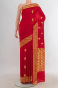 Pure Silk Red Banarasi Katan Saree with Zari Butta on the body and Silk Border.  displayed on a mannequin