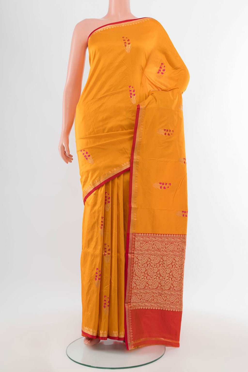 Yellow Banarasi Katan Silk Saree with Zari Butta on the body and Silk Border.  displayed on a mannequin