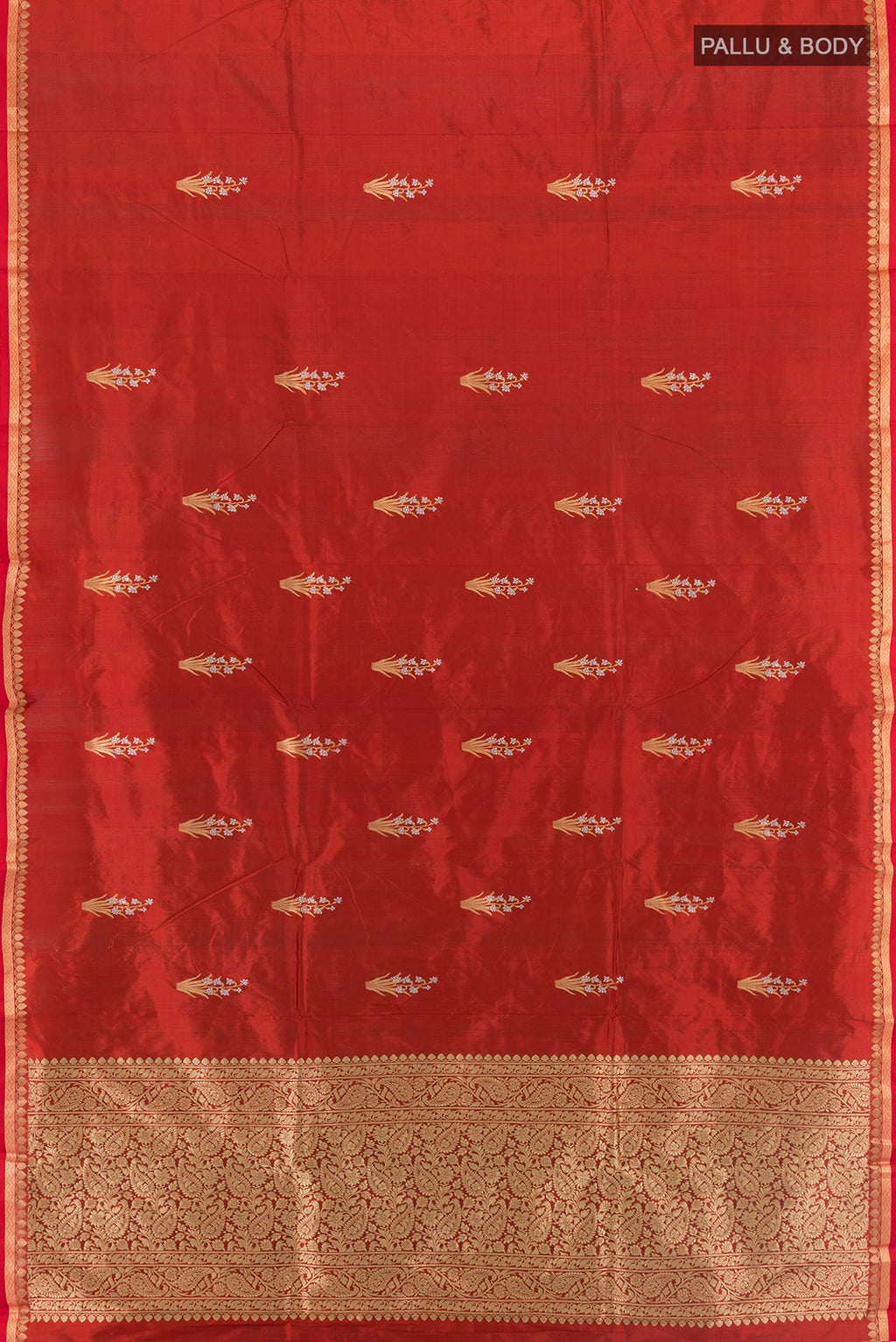 Flat view of Rust Banarasi Katan Silk Saree with Zari Butta on the body and Zari And Thread Border. 