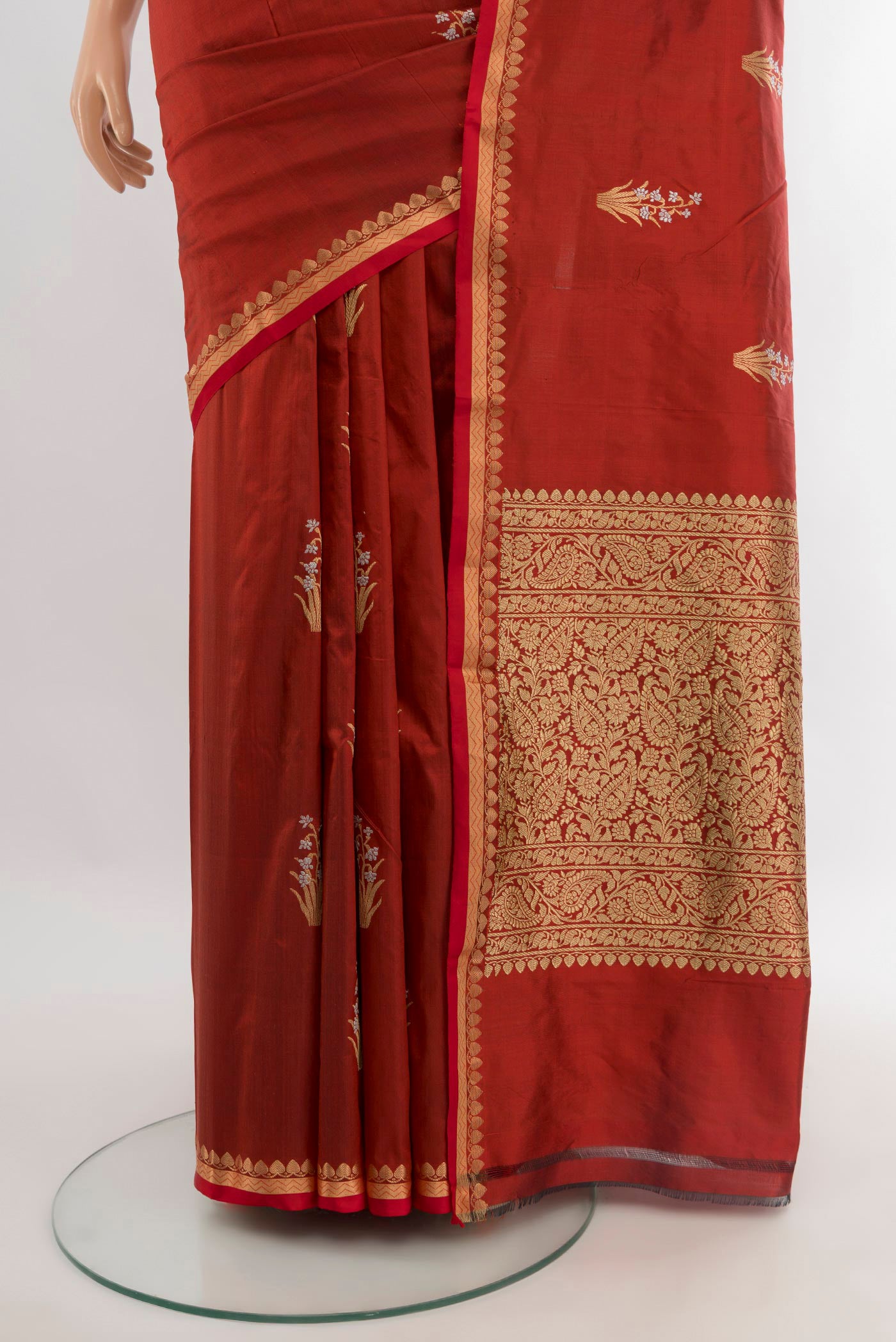 Pleats and pallu of Rust Banarasi Katan Silk Saree with Zari Butta on the body and Zari And Thread Border. 