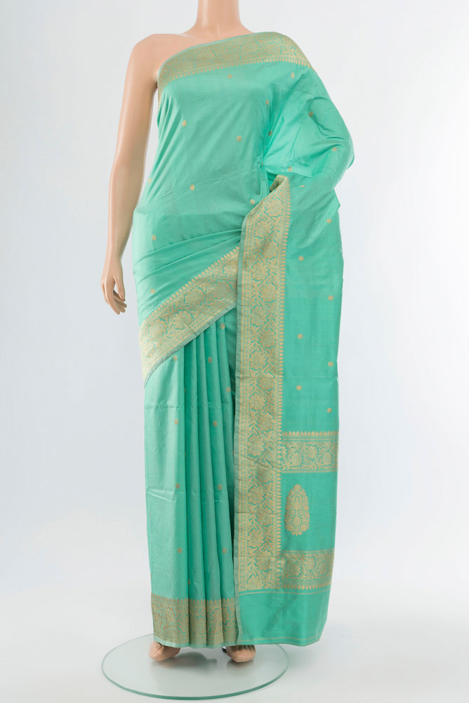 Sky Blue Banarasi Katan Silk Saree with Zari Butta on the body and Silk Border.  displayed on a mannequin