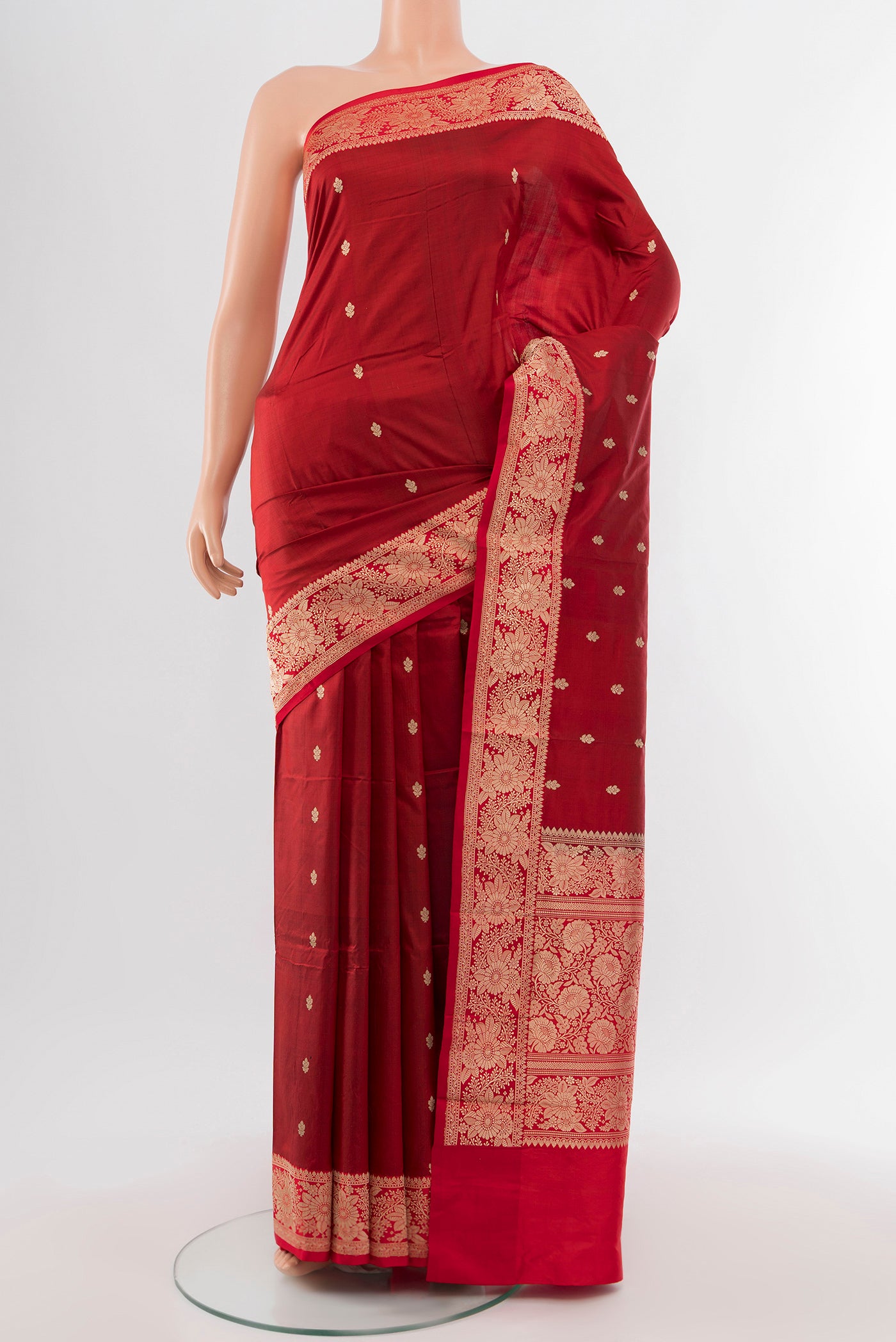 Maroon Banarasi Katan Silk Saree with Zari Butta on the body and Silk Border.  displayed on a mannequin