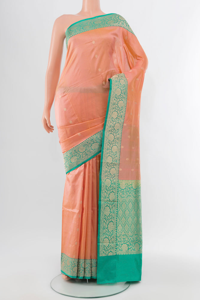 Rose Gold Soft Silk Saree with Zari Butta on the body and Silk Border.  displayed on a mannequin