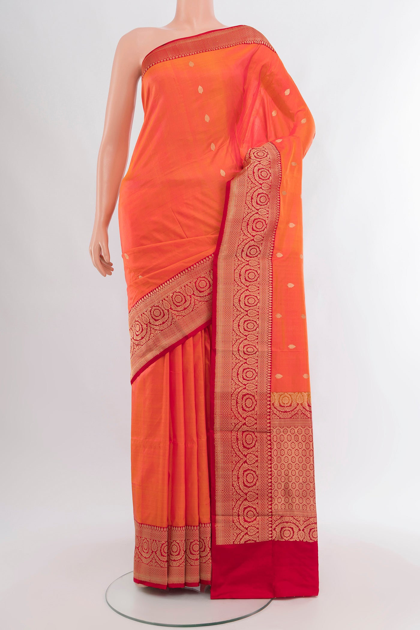 Peach Banarasi Katan Silk Saree with Zari Butta on the body and Zari Border.  displayed on a mannequin
