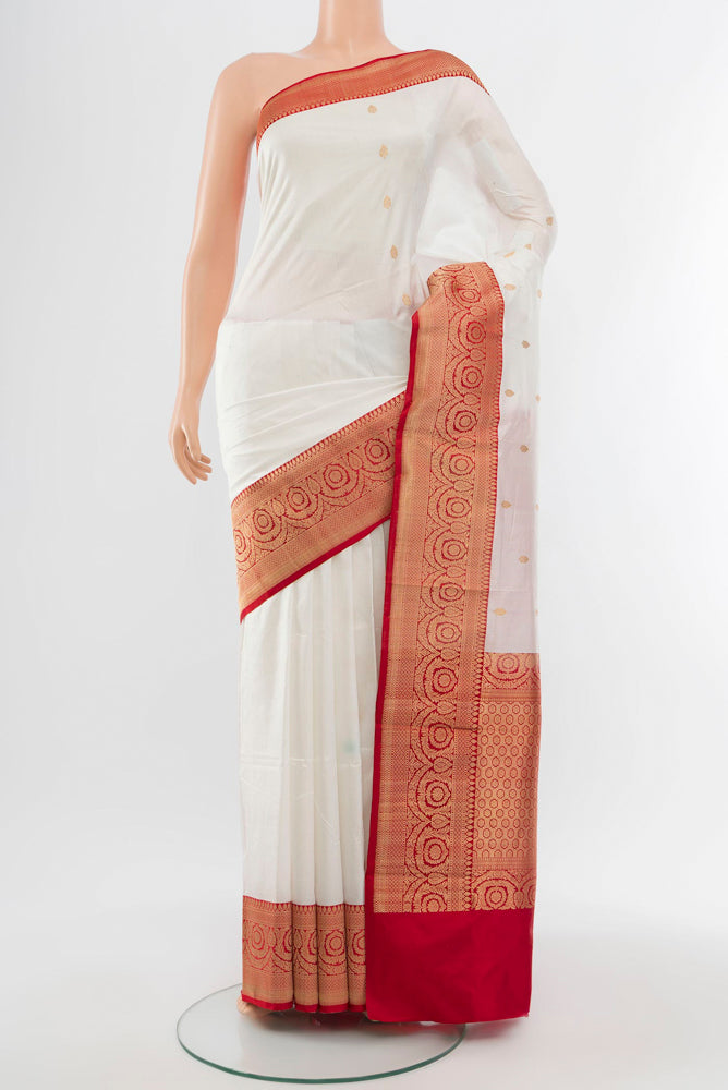 Cream Banarasi Katan Silk Saree with Zari Butta on the body and Silk Border.  displayed on a mannequin