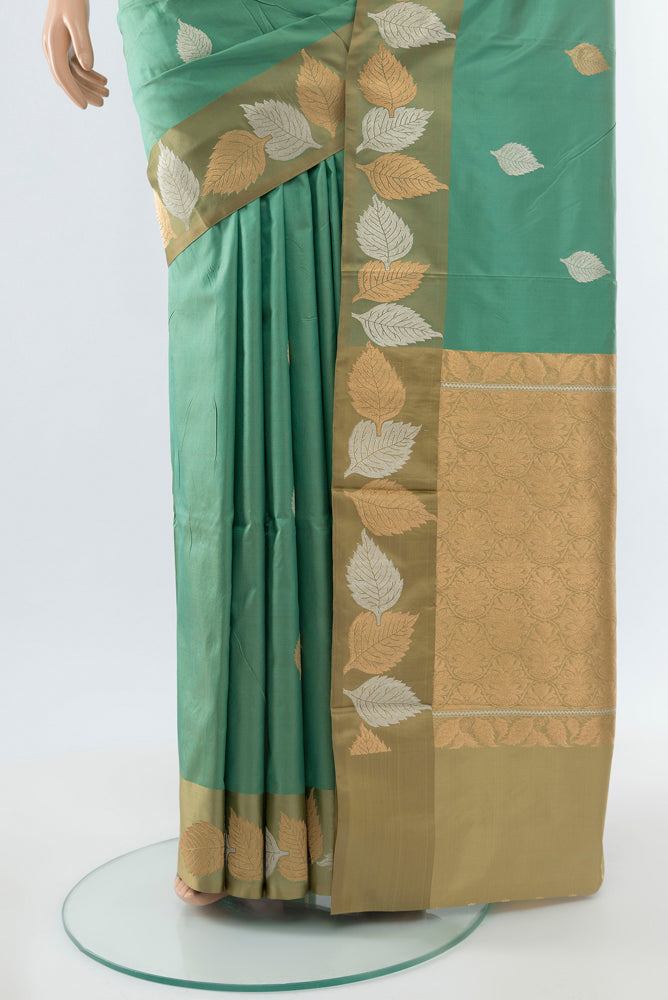 Pleats and pallu of Olive Green Banarasi Katan Silk Saree with Zari Butta on the body and Silk Border. 