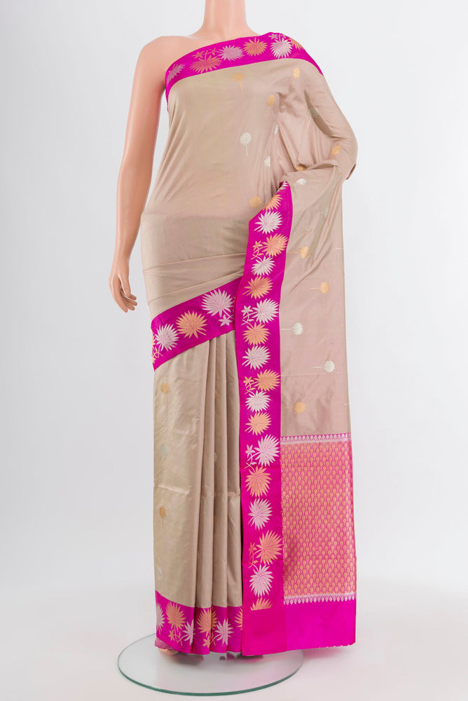 Beige Banarasi Katan Silk Saree with Zari Butta on the body and Silk Border.  displayed on a mannequin
