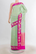 Pure Silk Pista Green Banarasi Katan Saree with Zari Butta on the body and Zari Border.  displayed on a mannequin
