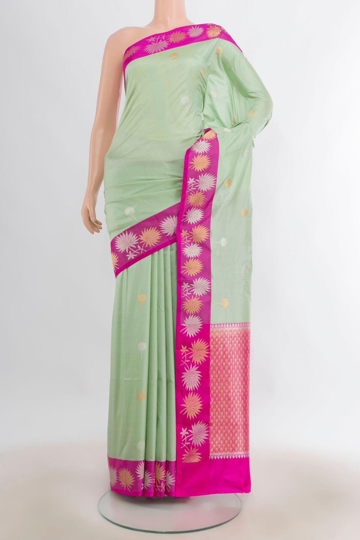 Pure Silk Pista Green Banarasi Katan Saree with Zari Butta on the body and Zari Border.  displayed on a mannequin