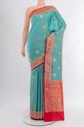 Light Blue Banarasi Katan Silk Saree with Zari Butta on the body and Zari Border.  displayed on a mannequin