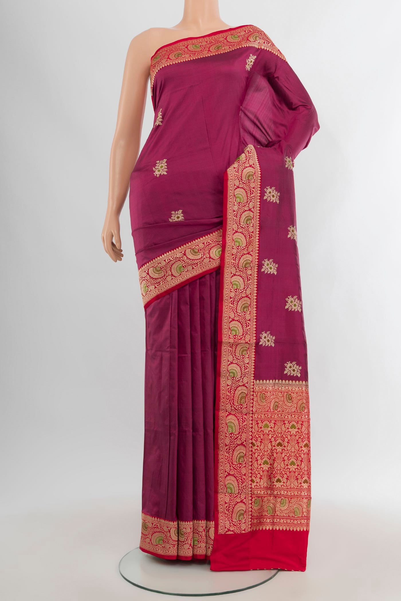 Magenta Banarasi Katan Silk Saree with Zari Butta on the body and Zari Border.  displayed on a mannequin