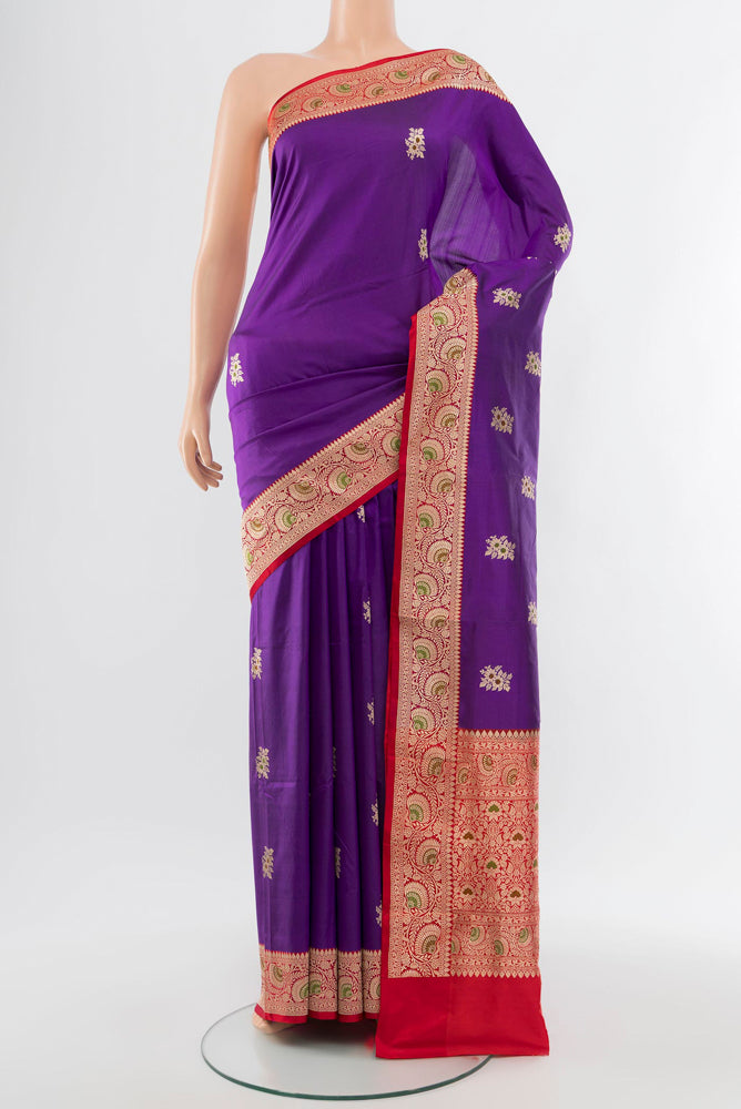 Violet Banarasi Katan Silk Saree with Zari Butta on the body and Silk Border.  displayed on a mannequin